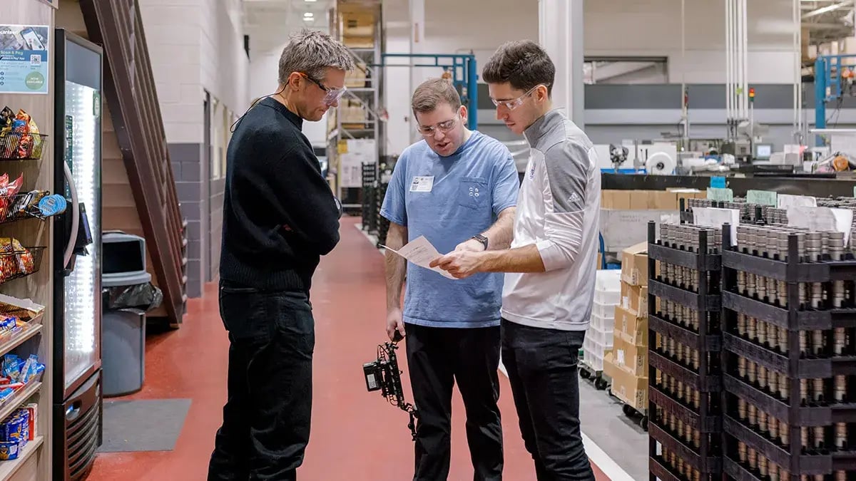 team members from Camcraft, Inc and Charter & Co review a filming schedule during a video production