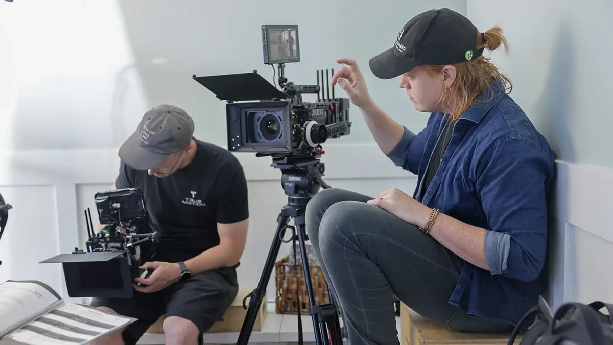 A video producer from Charter & Co captures b-roll on a RED digital cinema video camera.