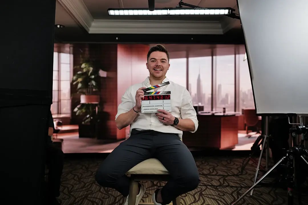 a customer holds a film slate during a testimonial video production