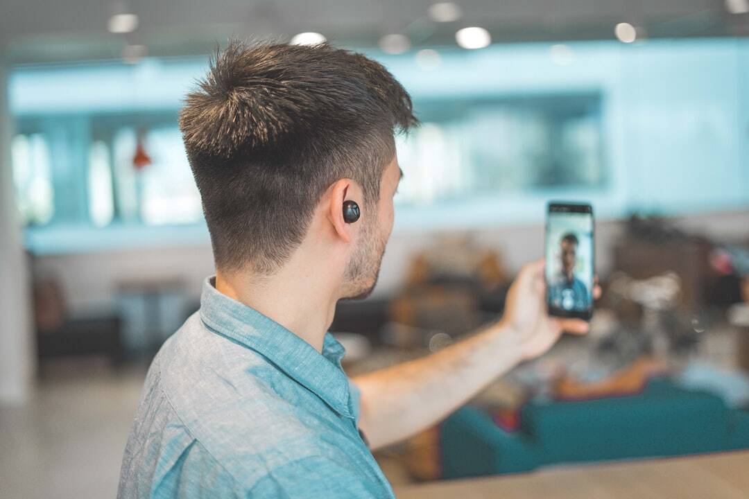 a man watches a short form video on his mobile phone